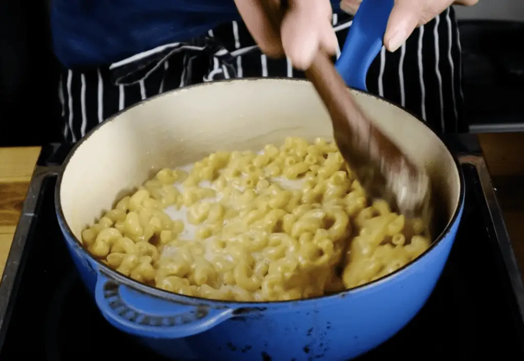 Stirring Stove top mac and cheese