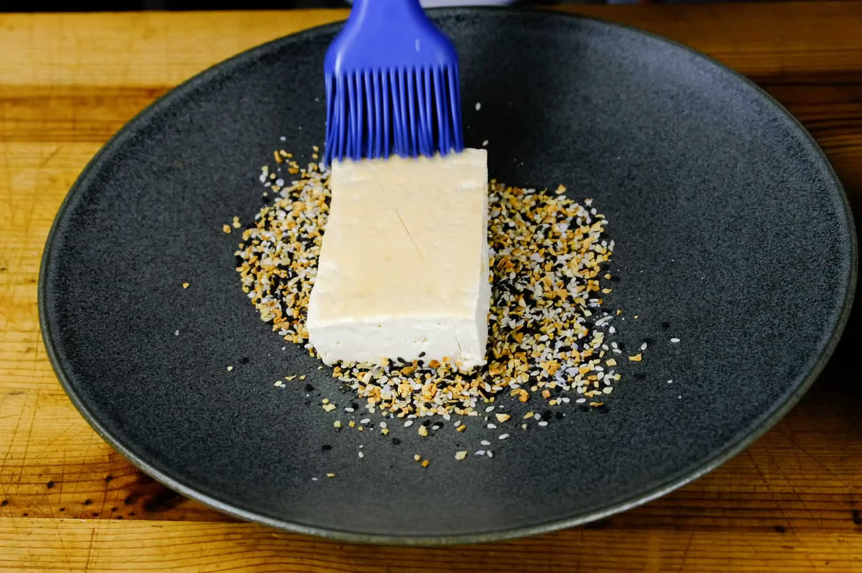 BRUSHING SESAME OIL ON OTHER SIDE OF TOFU
