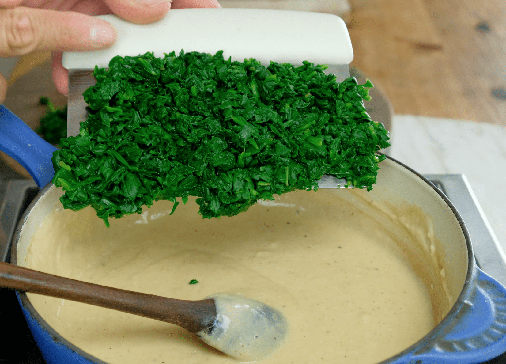 ADDING COOKED SPINACH TO BASE
