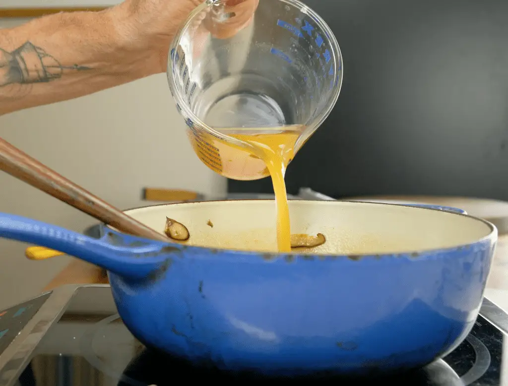 ADDING VEGETABLE BROTH TO SHIITAKE MUSHROOMS