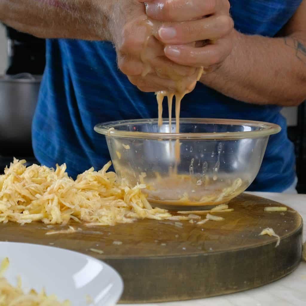 removing water from shredded potatoes by hand