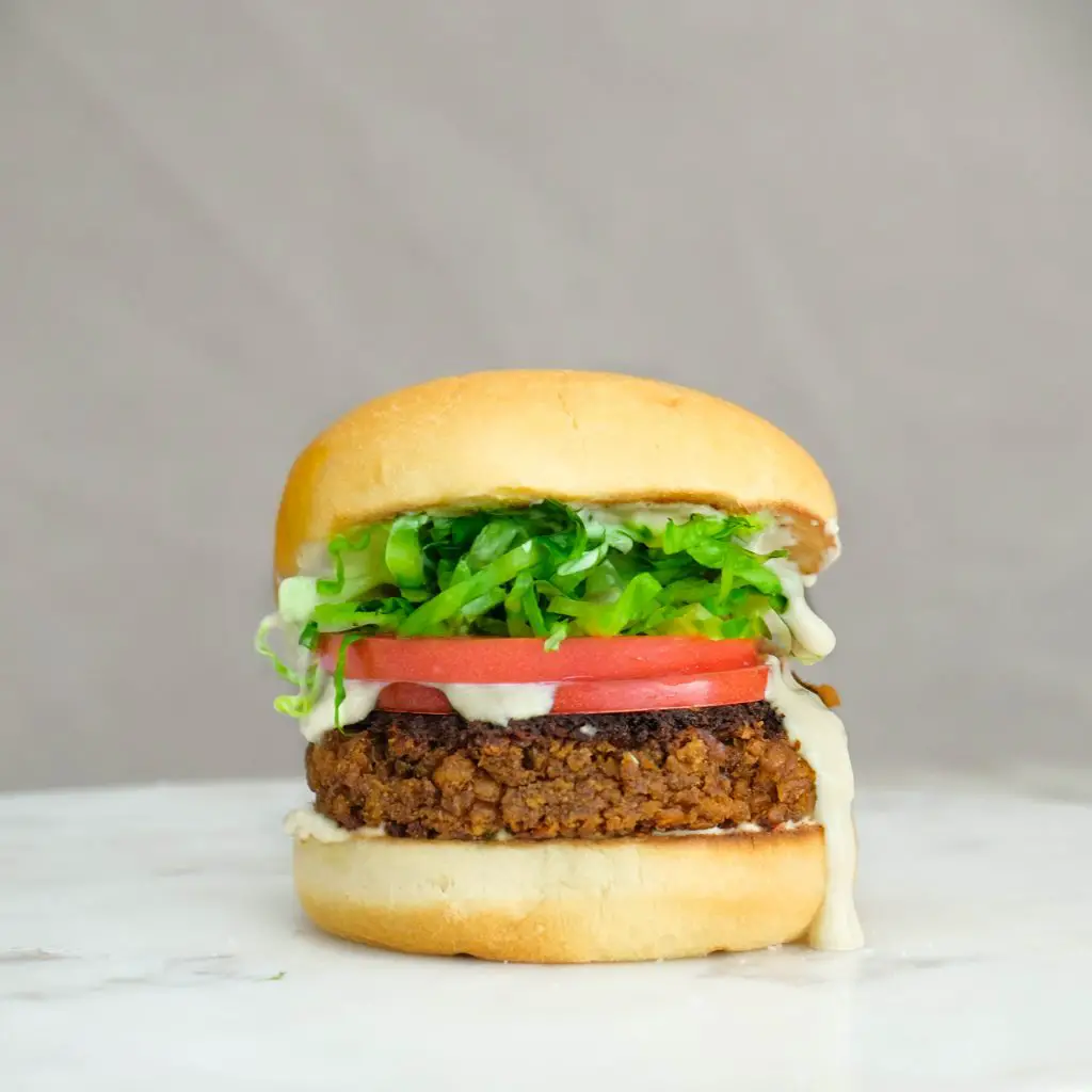vegan lentil burger, vegan mayo, lettuce, tomato
