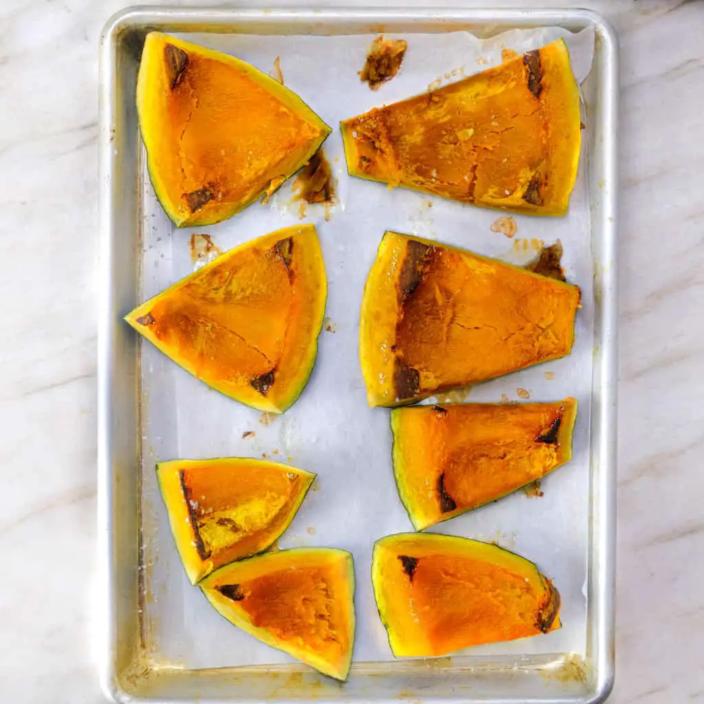 Cut kabocha squash with seeds removed, portioned and roasted for vegan gnocchi