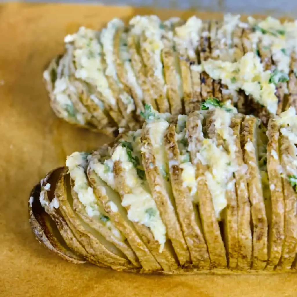 baked hasselback potato with herb vegan butter_