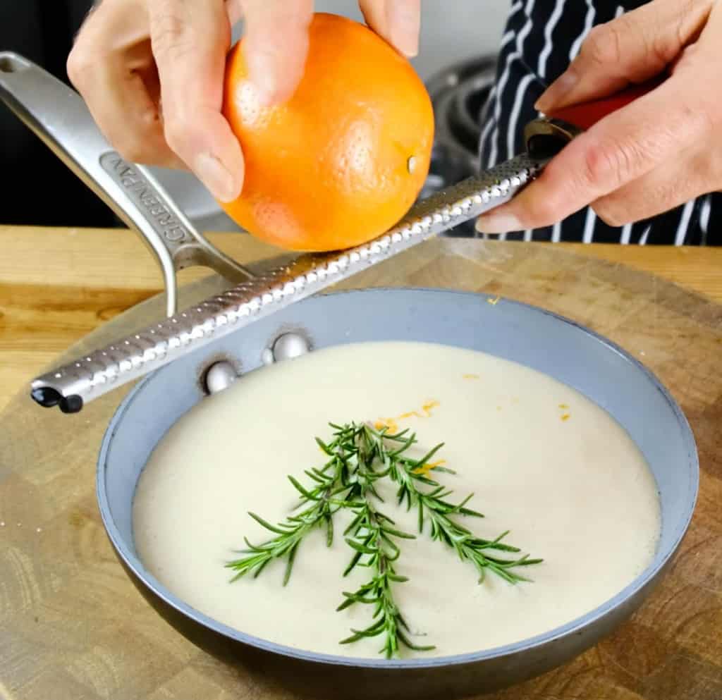 GRATING ORANGE ZEST FOR ORANGE VEGAN BEURRE BLANC