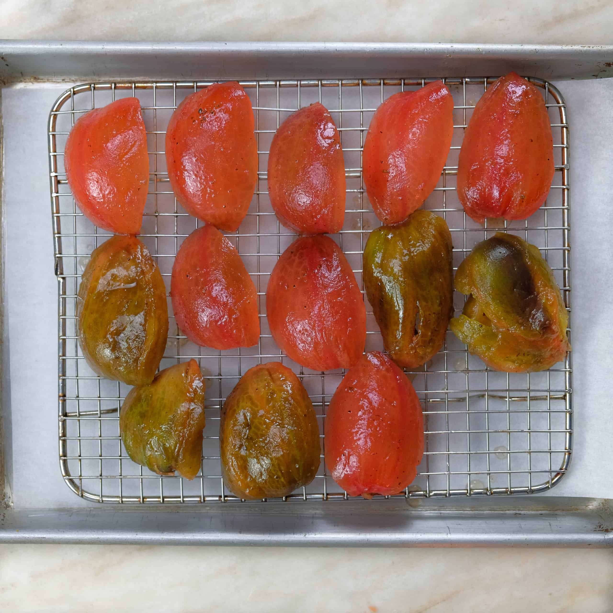 marinaded peeled and seeded tomatoes cut into quarters ready to bake