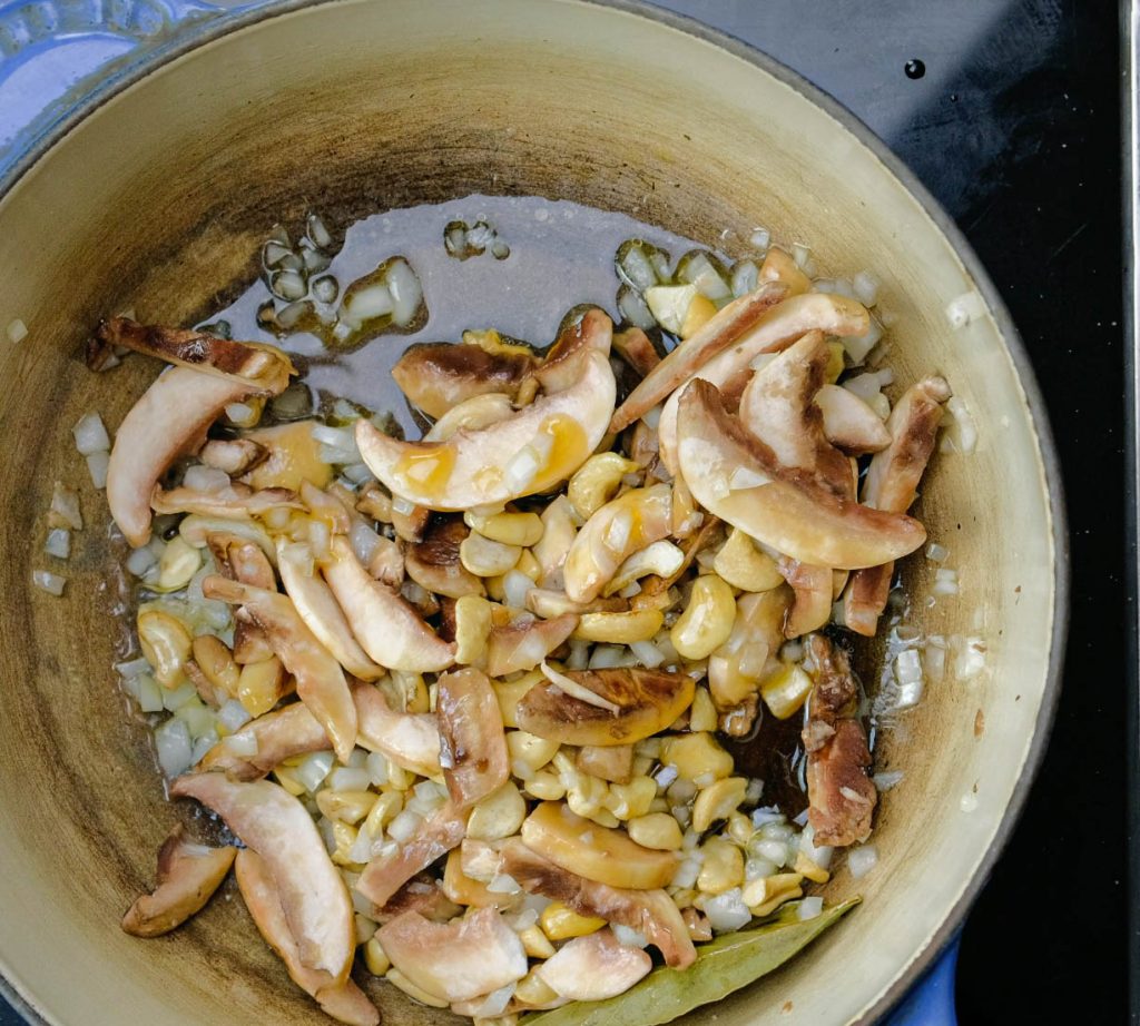 cooking diced onion, button mushroom, cashews, bay leaf for vegan heavy cream