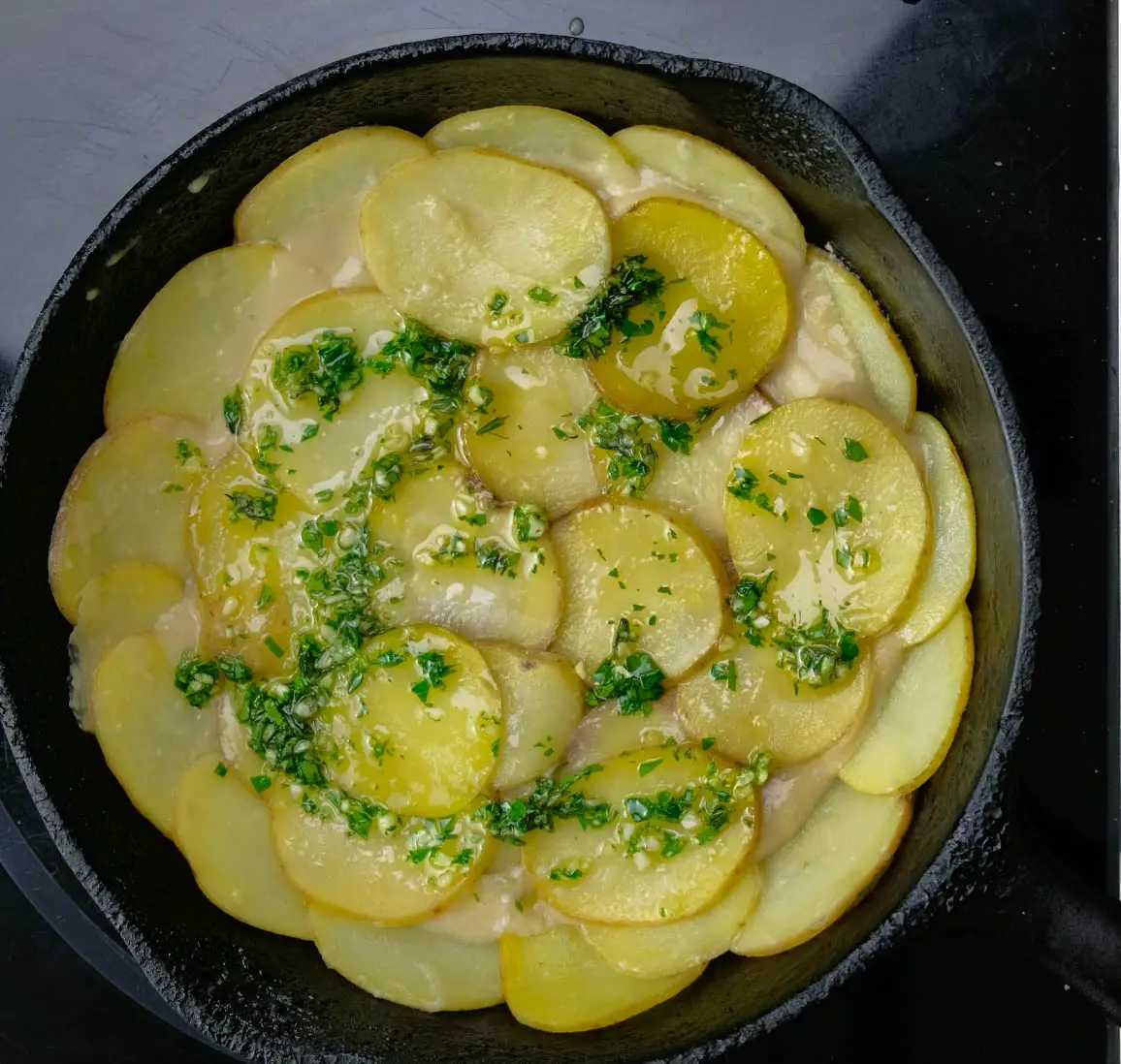 third layer of potatoes, thyme, garlic, oil vegan scalloped potatoes