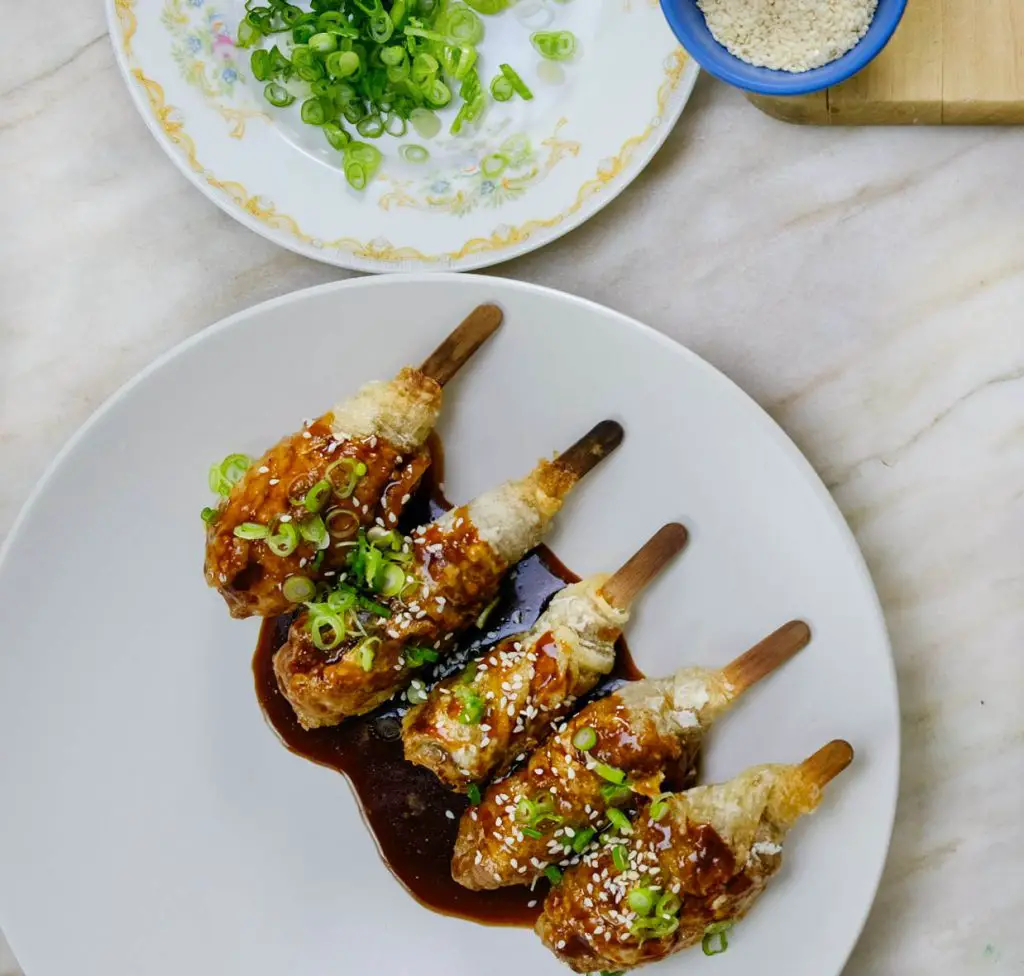 VEGAN CHICKEN DRUMETTES IN SPICY STICKY SAUCE, SCALLIONS