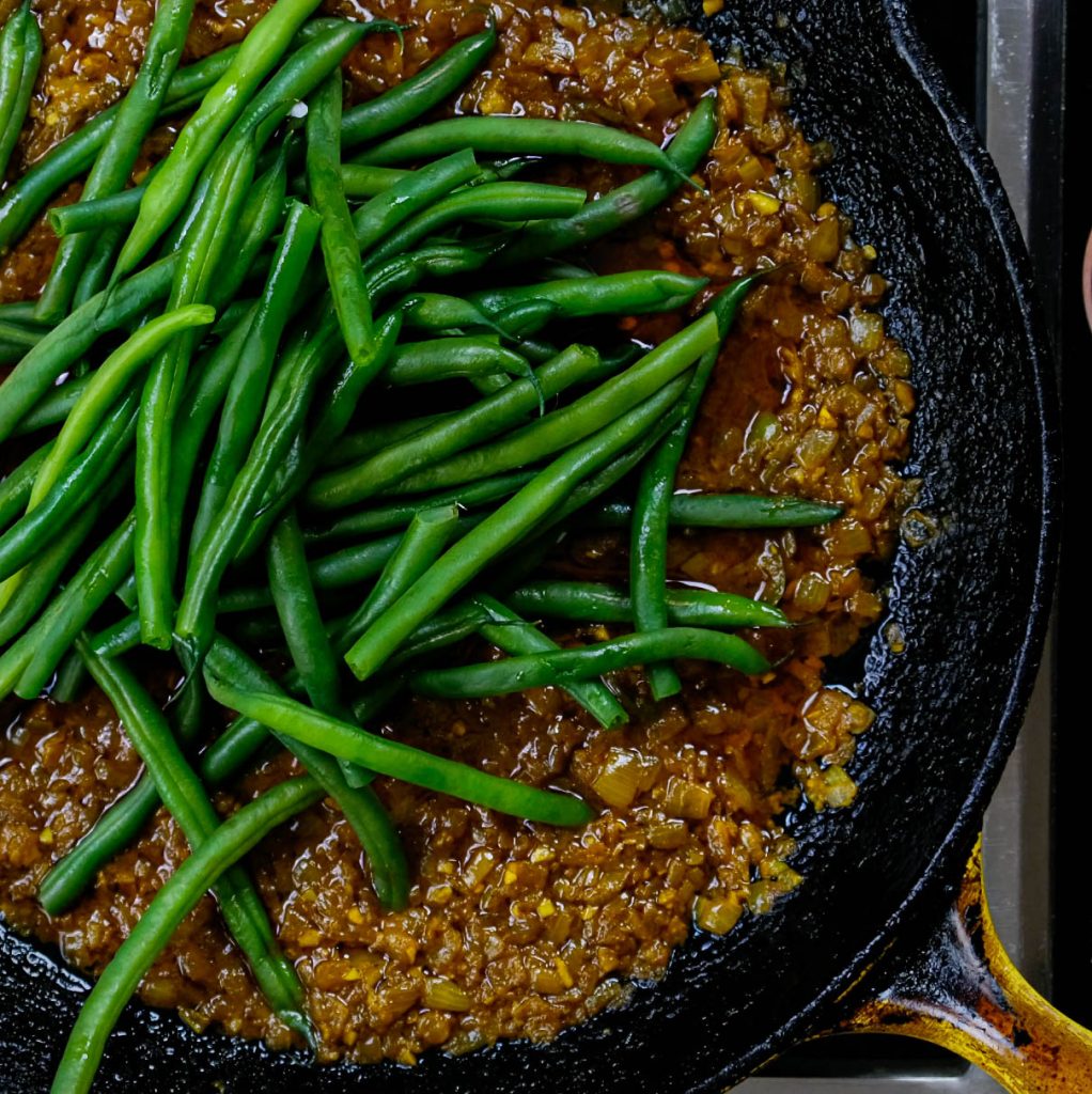 GREEN WITH BRAISED SPICES, ONIONS, GARLIC AND SERRANO CHILI FOR VEGAN SHRIMP STIR FRY_