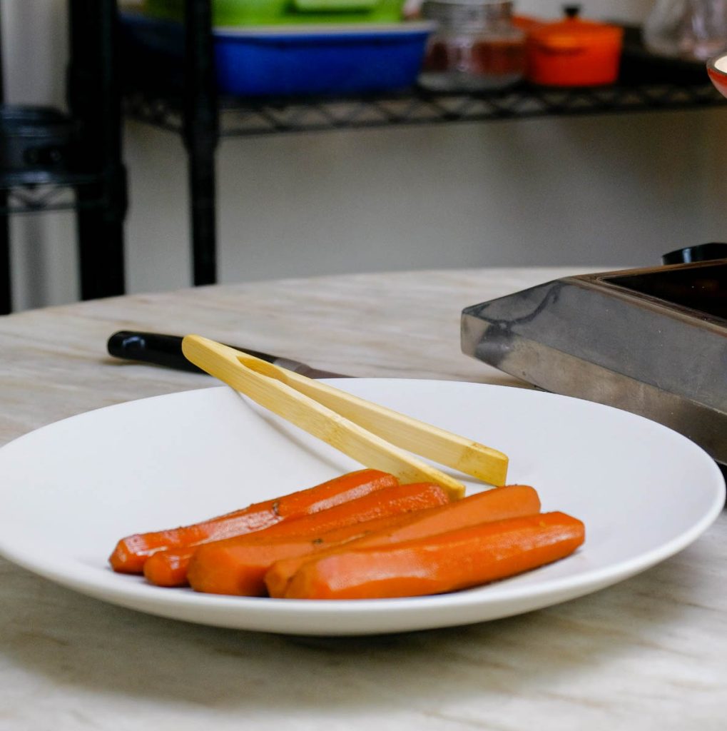 POACHED CARROT DOG IN BRINE ON PLATE