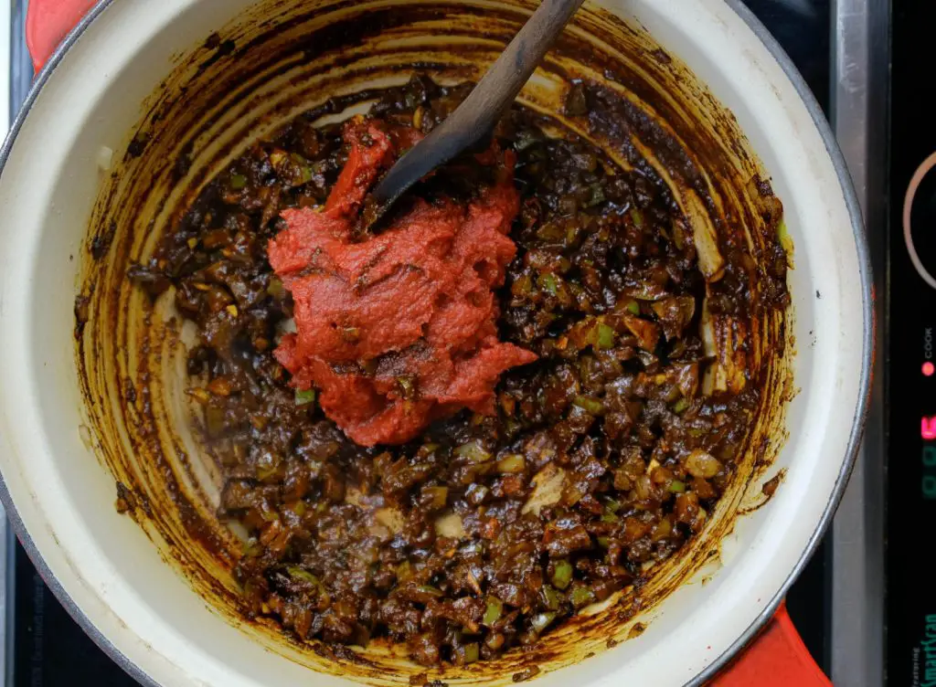 cooking tomato paste, spices, and ingredients for vegan sloppy joes